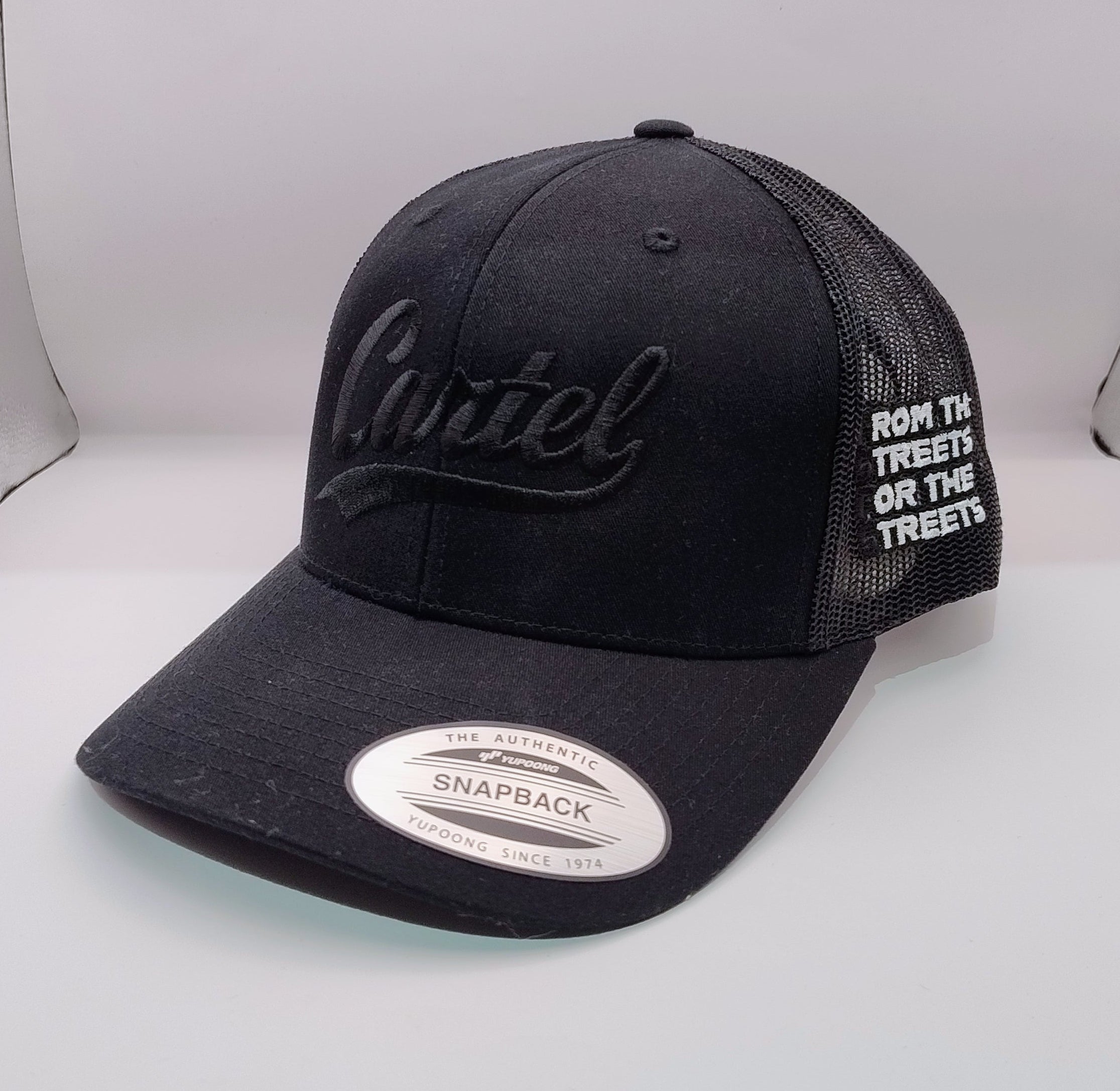 Black cap with white text on a gray surface